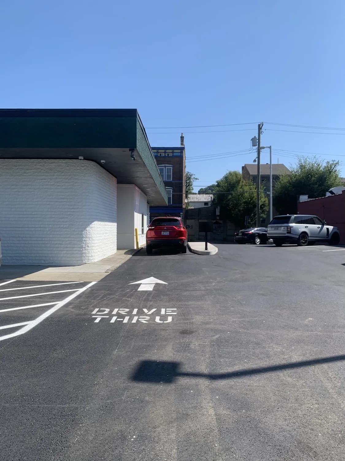 The drive-thru lane at The Garden, with DRIVE THRU and an arrow painted on the pavement