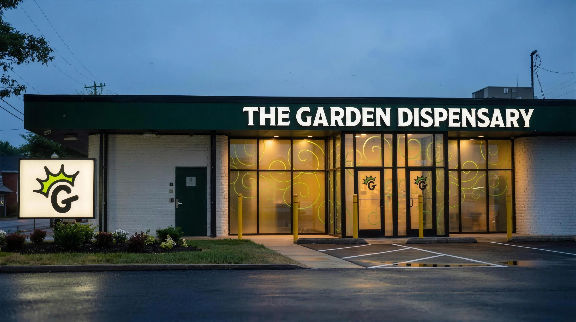 The Garden Dispensary in Camp Washington at dusk: the lit storefront on Colerain Avenue under the white THE GARDEN DISPENSARY sign, with the crowned G sign by the lot