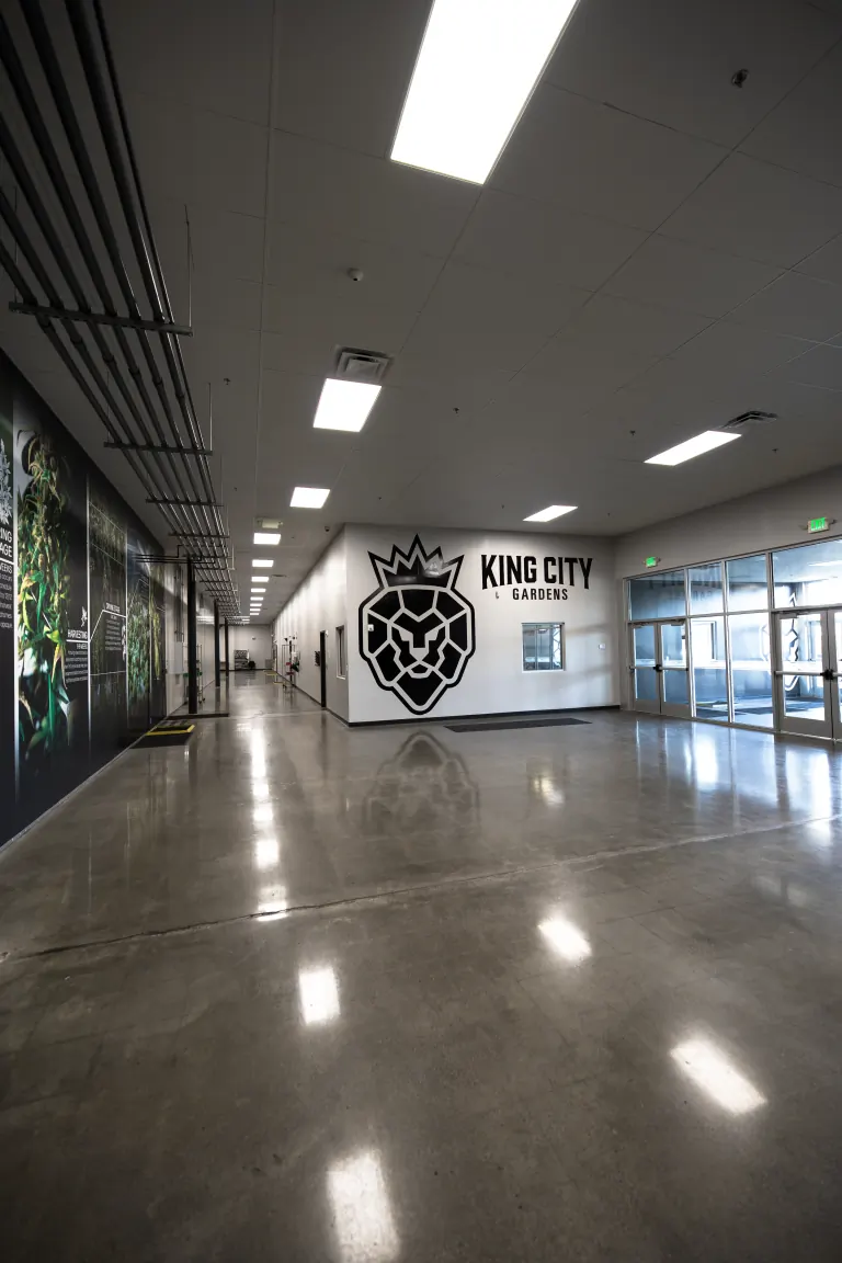 The main corridor of the King City Gardens grow in Forest Park, Ohio, with the crowned lion crest and KING CITY GARDENS lettering on the far wall